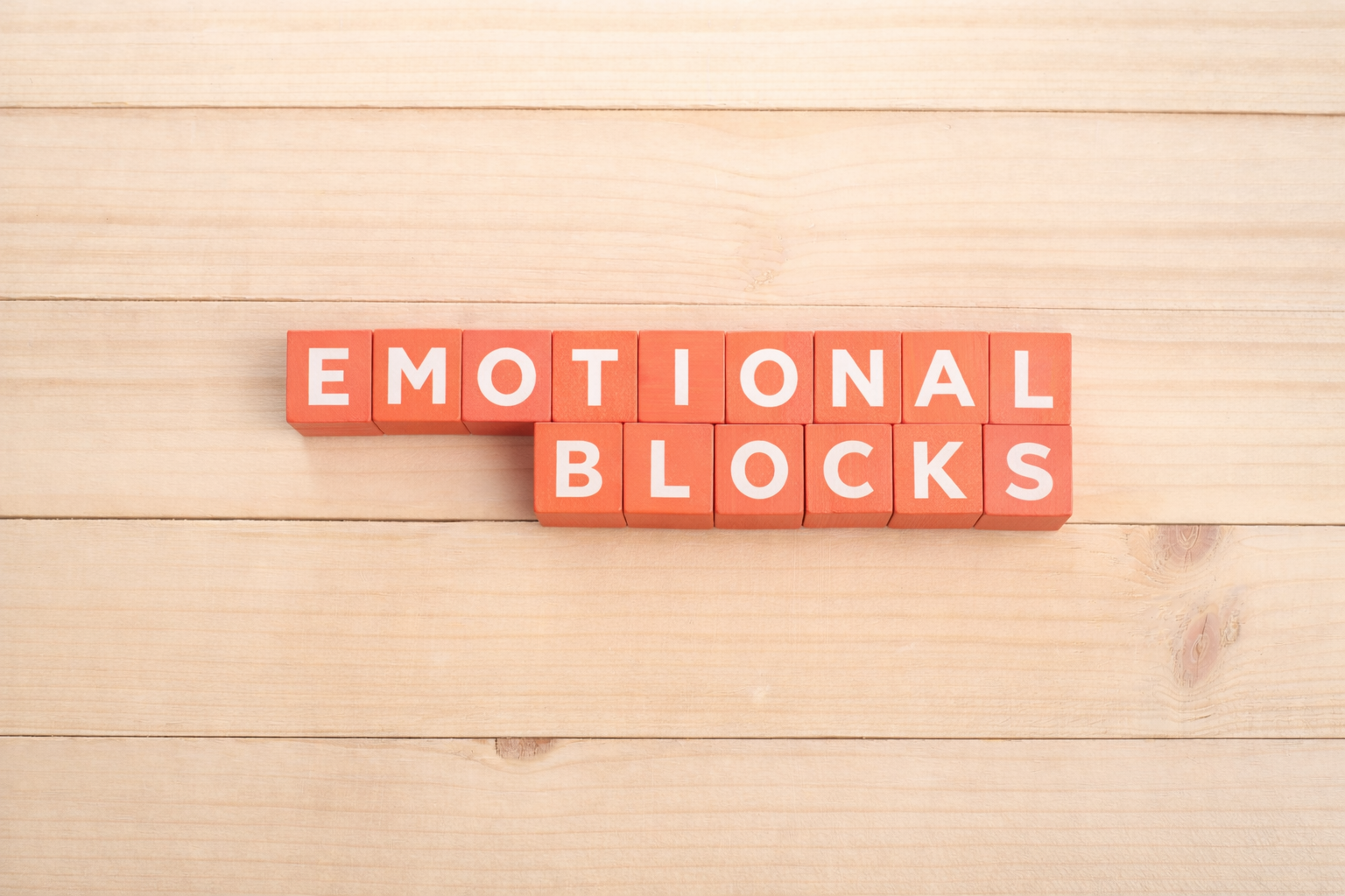 Emotional blocks concept with coral letter blocks representing imposter syndrome, anxiety and low self-esteem therapy in Greenwich London